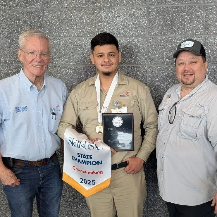 Three men holding a SkillsUSA State Champion Cabinetmaking 2025 pennant and plaque