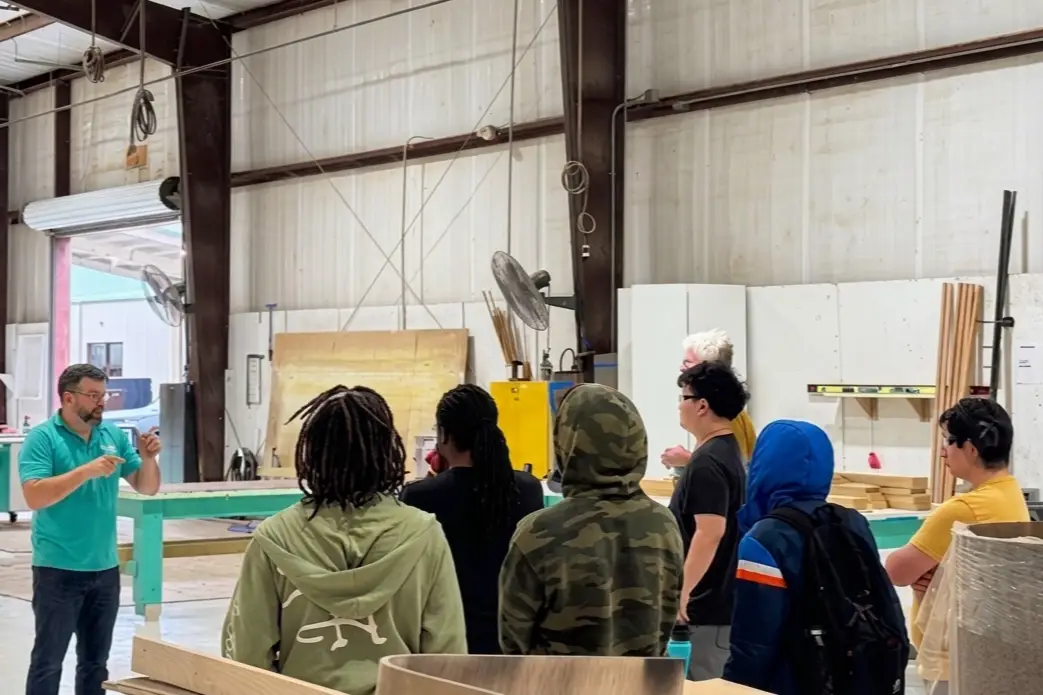 Students on a hands-on tour of the Dovetail shop with a team member