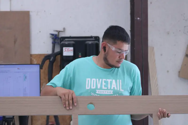 Dovetail craftsman holding a finished panel