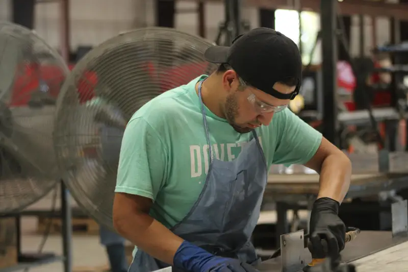 Metal fabricator at the bench in the Dovetail metal shop