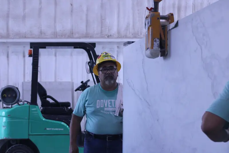 Stone shop team member working a slab