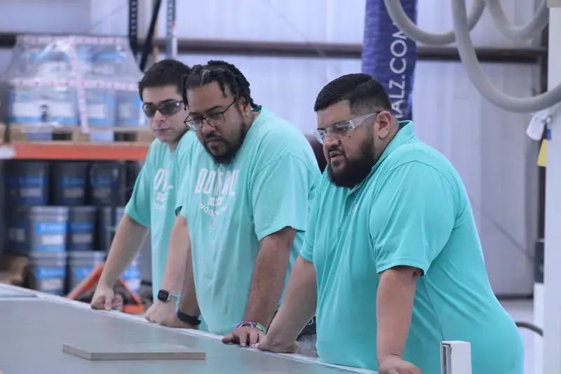 Three Dovetail crew members working together at a bench