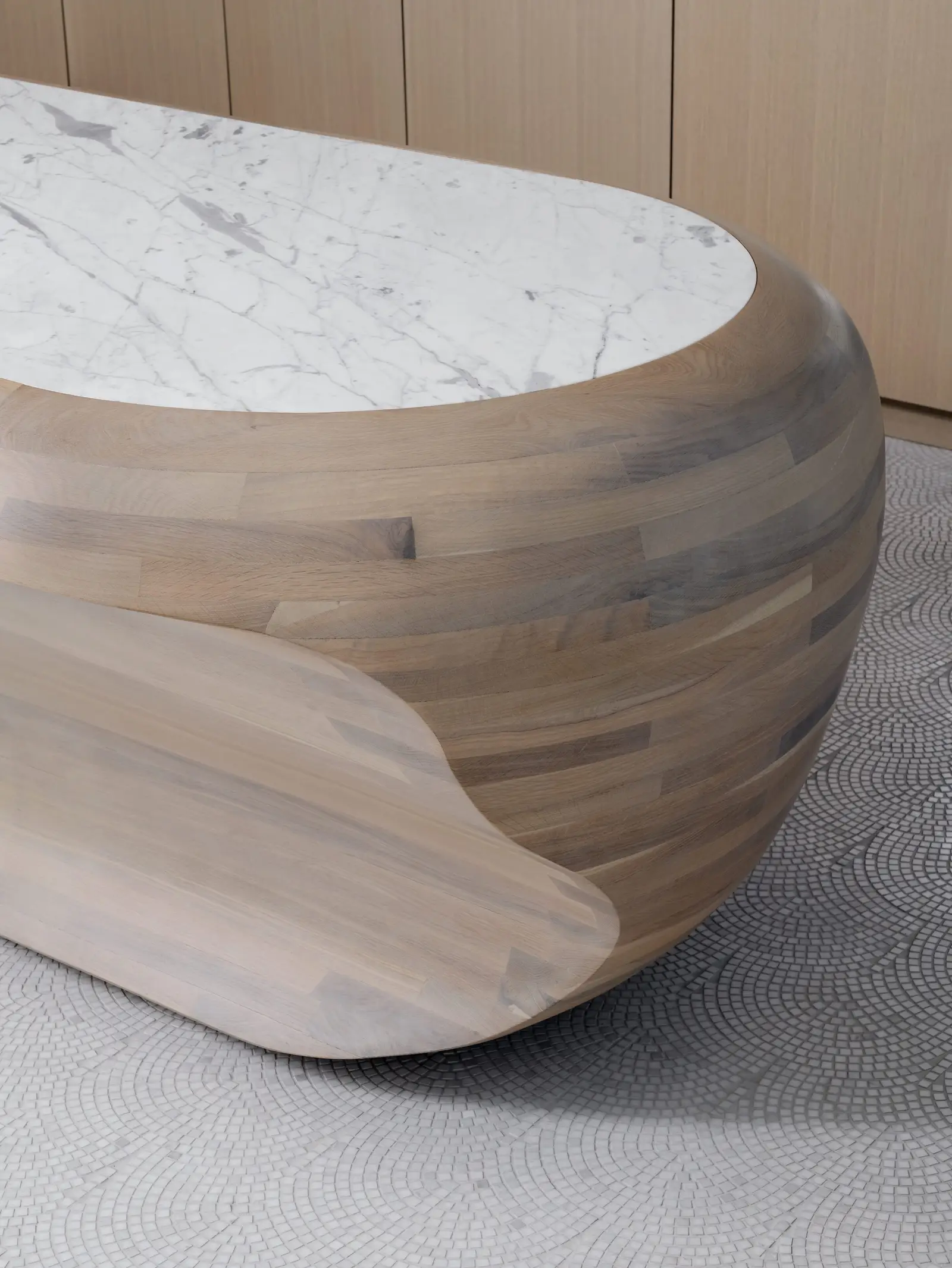 44 East close view of a sculpted laminated wood island with a stone top