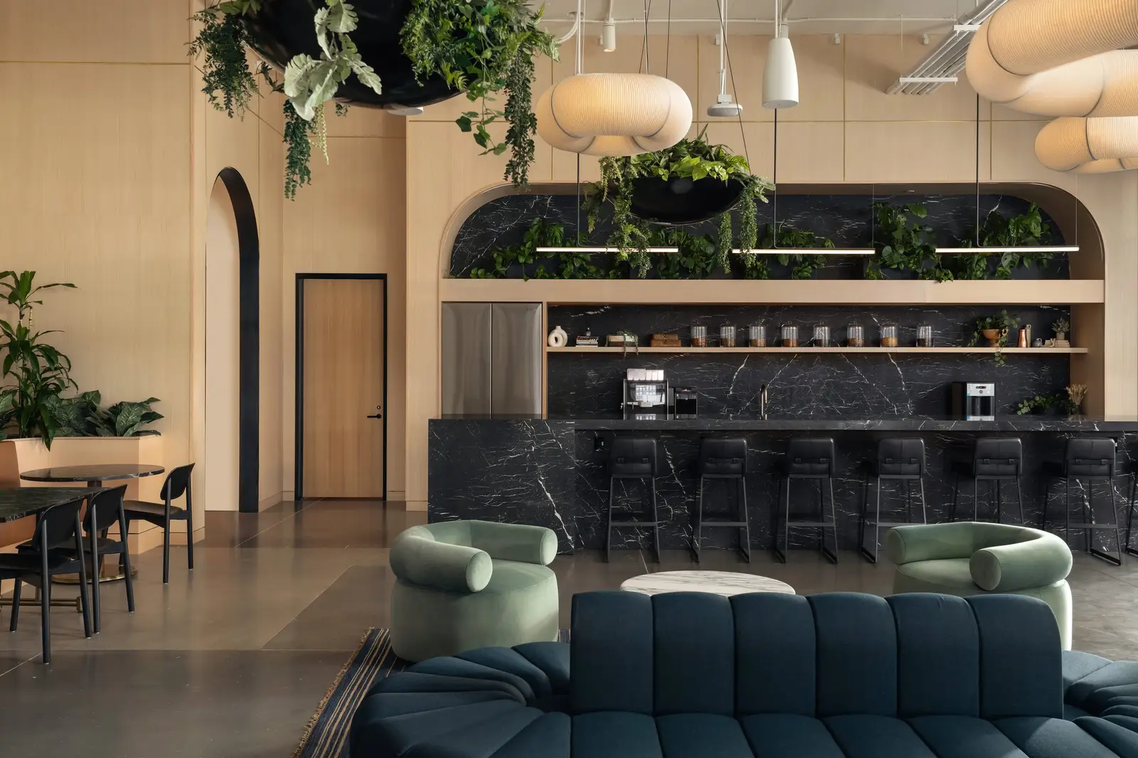 Atmosphere TV lounge seating before a bar with an arched plant niche