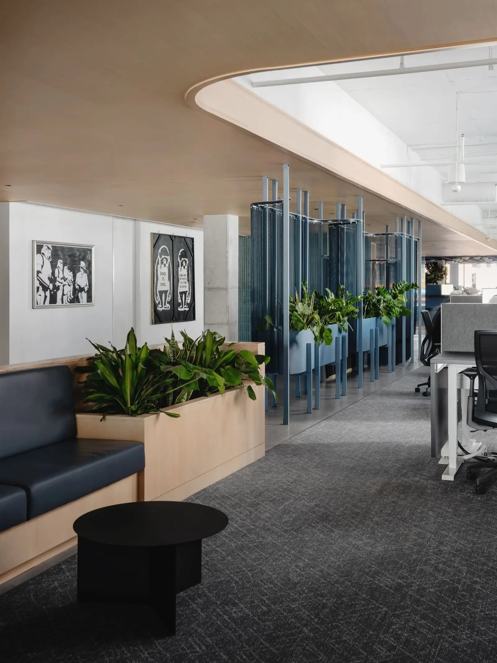 Atmosphere TV corridor with a bench, planters and a logo wall