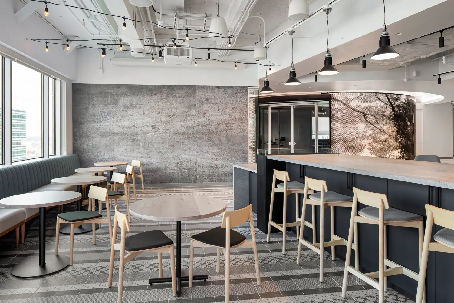 Boston Consulting Group cafe seating with a high counter and a stone-patterned wall