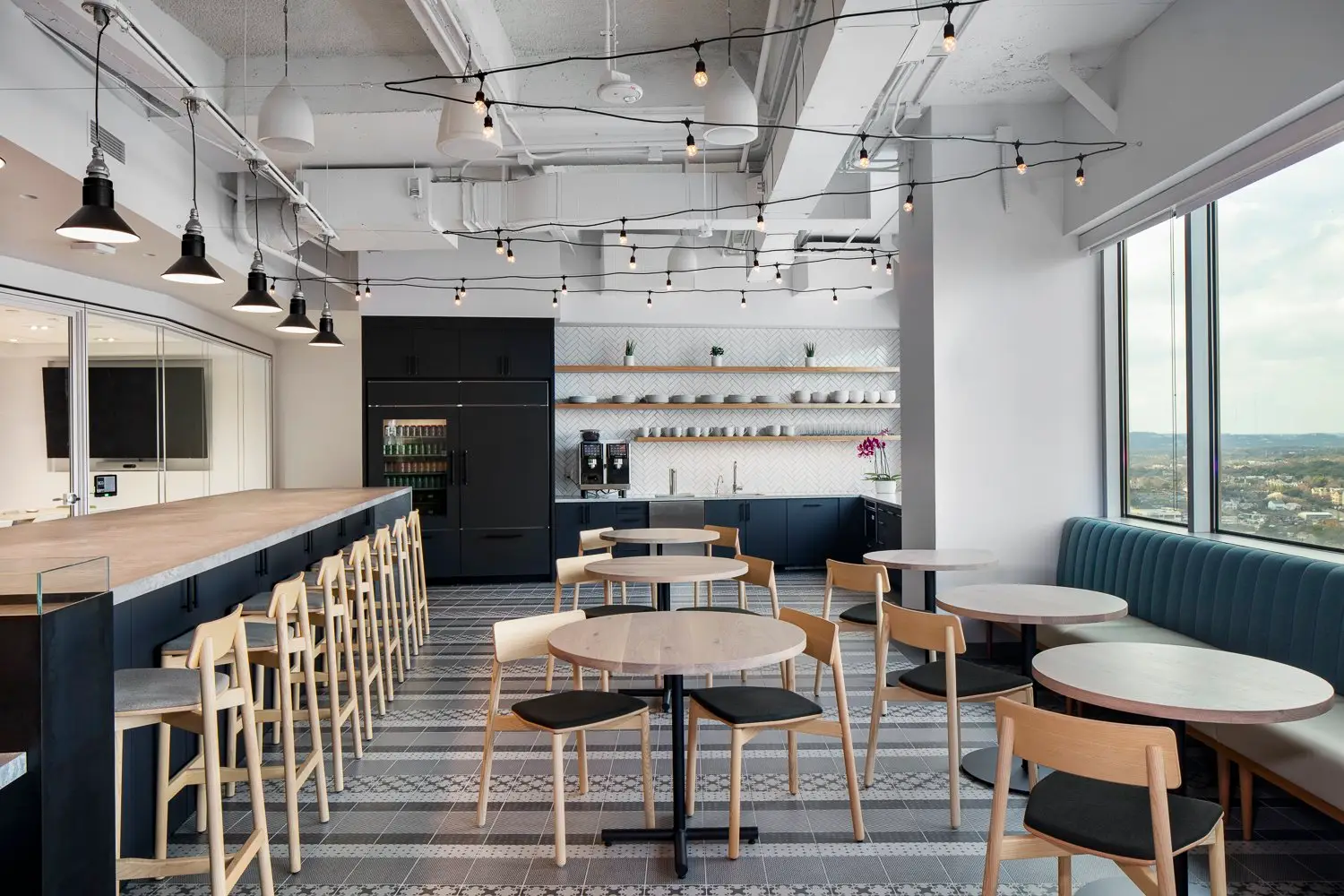 Boston Consulting Group cafe area with a long counter, stools and round tables