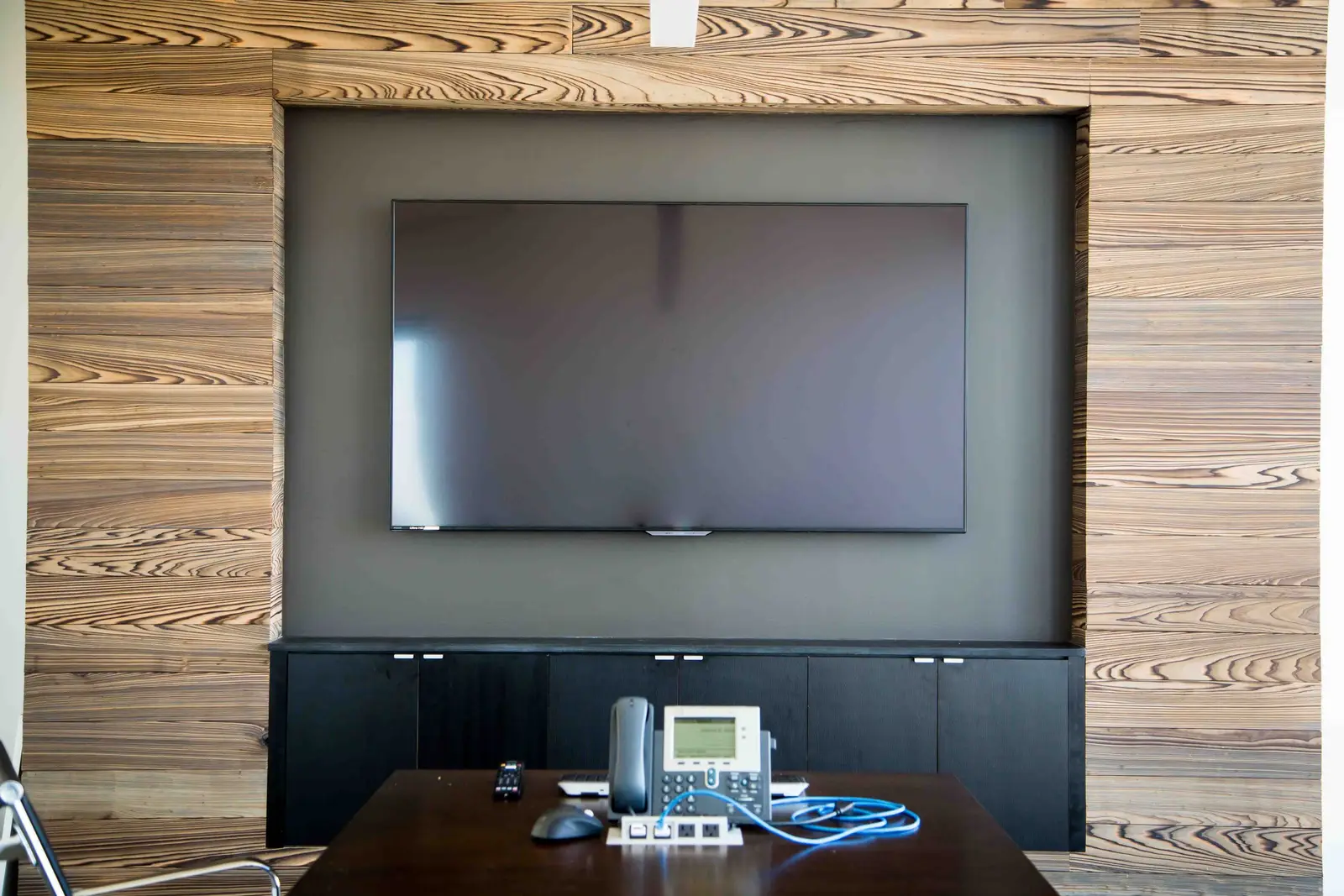 Boka Powell wood wall with a recessed TV niche and a dark credenza