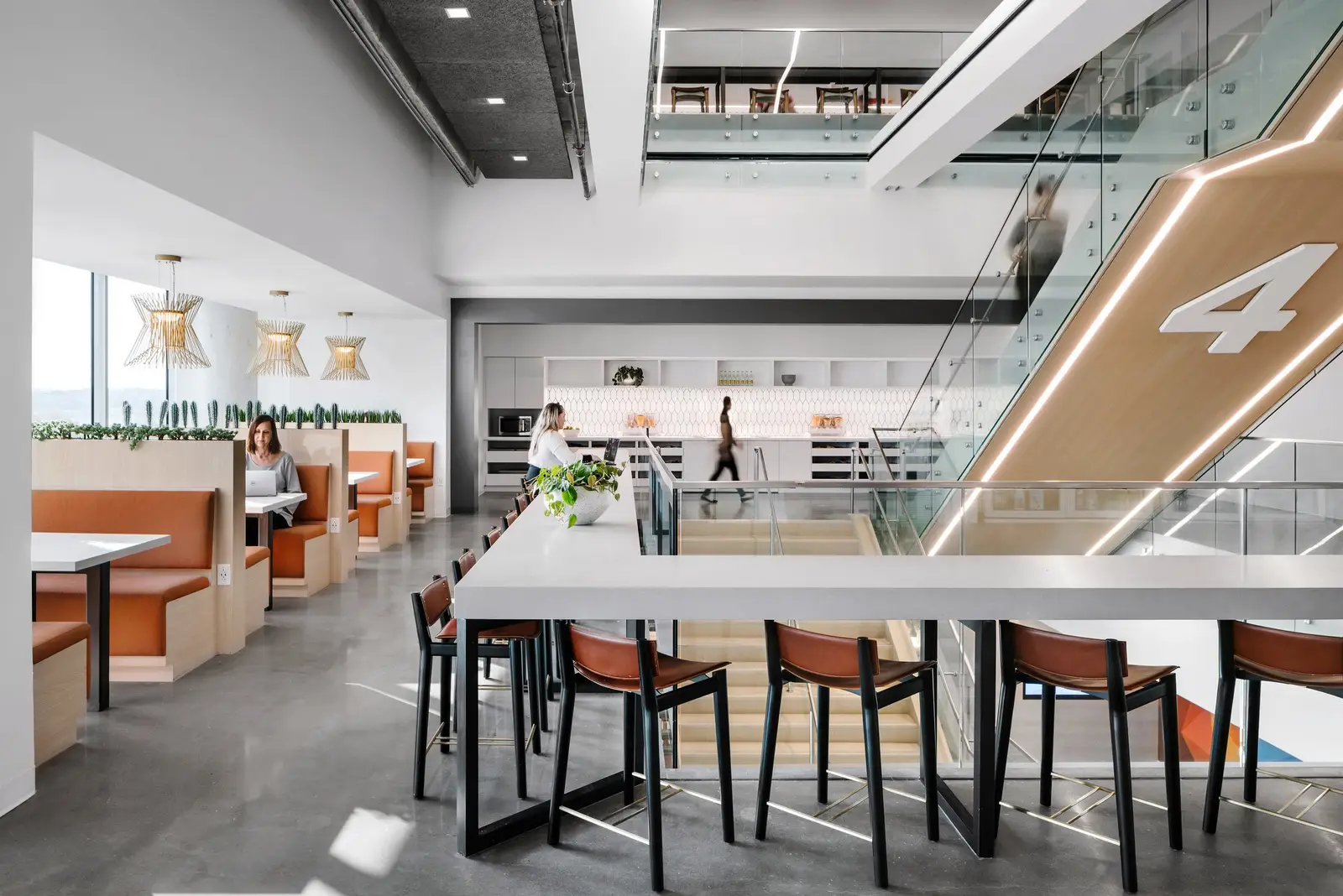 Indeed communal area with booth seating and a stair marked with the number 4