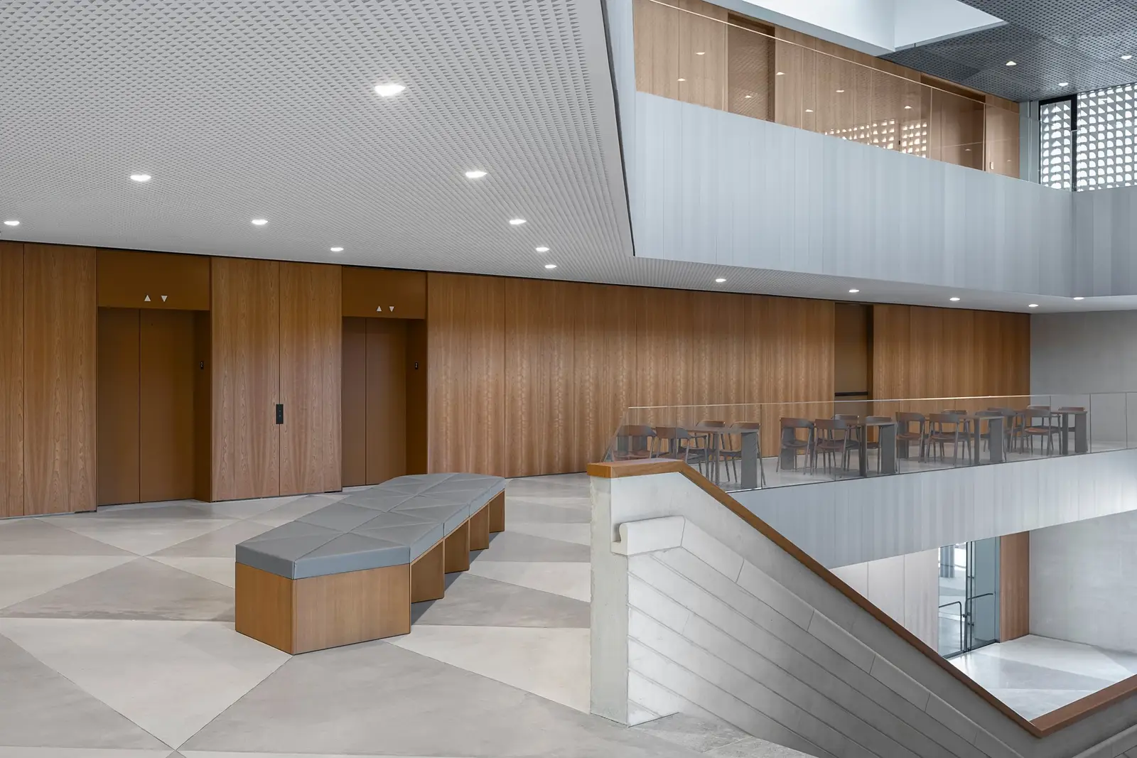 Ismaili Centre lobby with wood-paneled walls, a pale floor and a bench