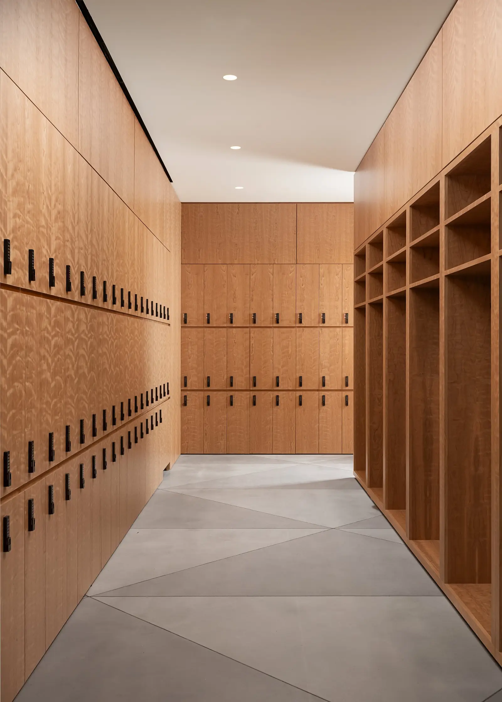 Ismaili Centre narrow wood locker corridor with small lockers and open shelving