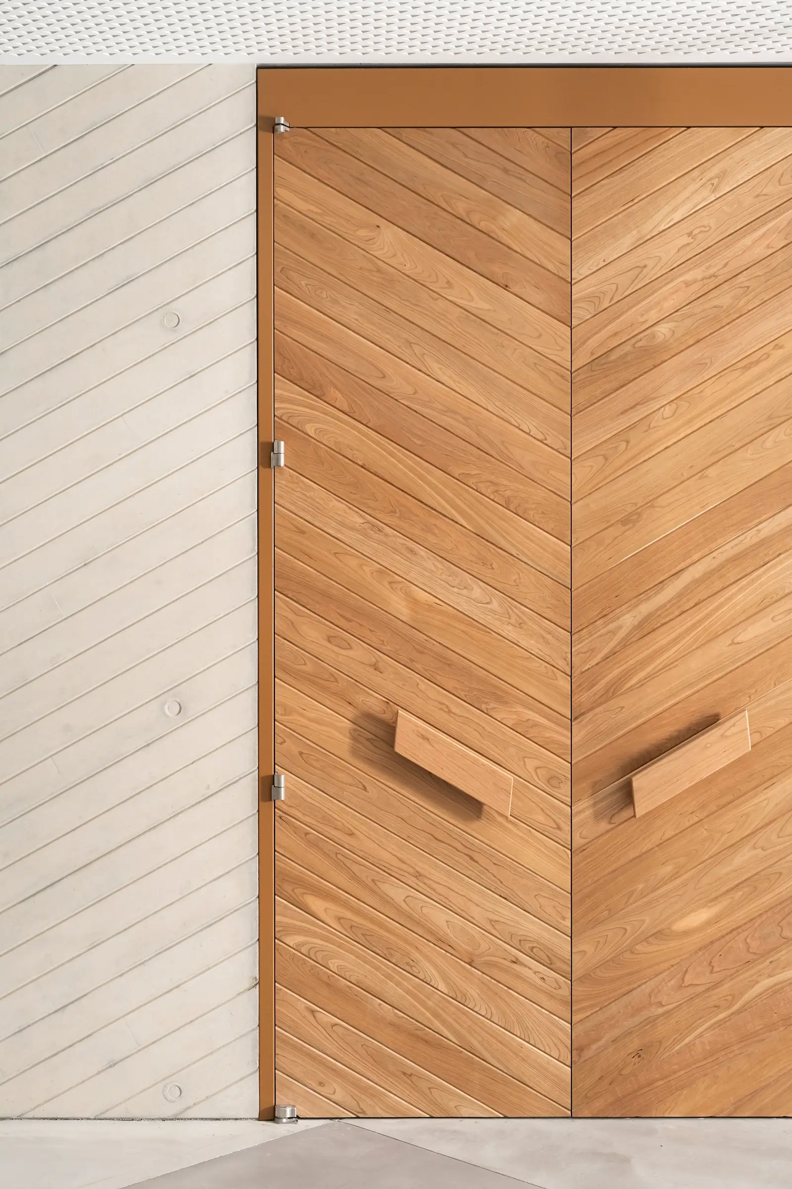 Ismaili Centre close view of a chevron-pattern wood door with wood pulls
