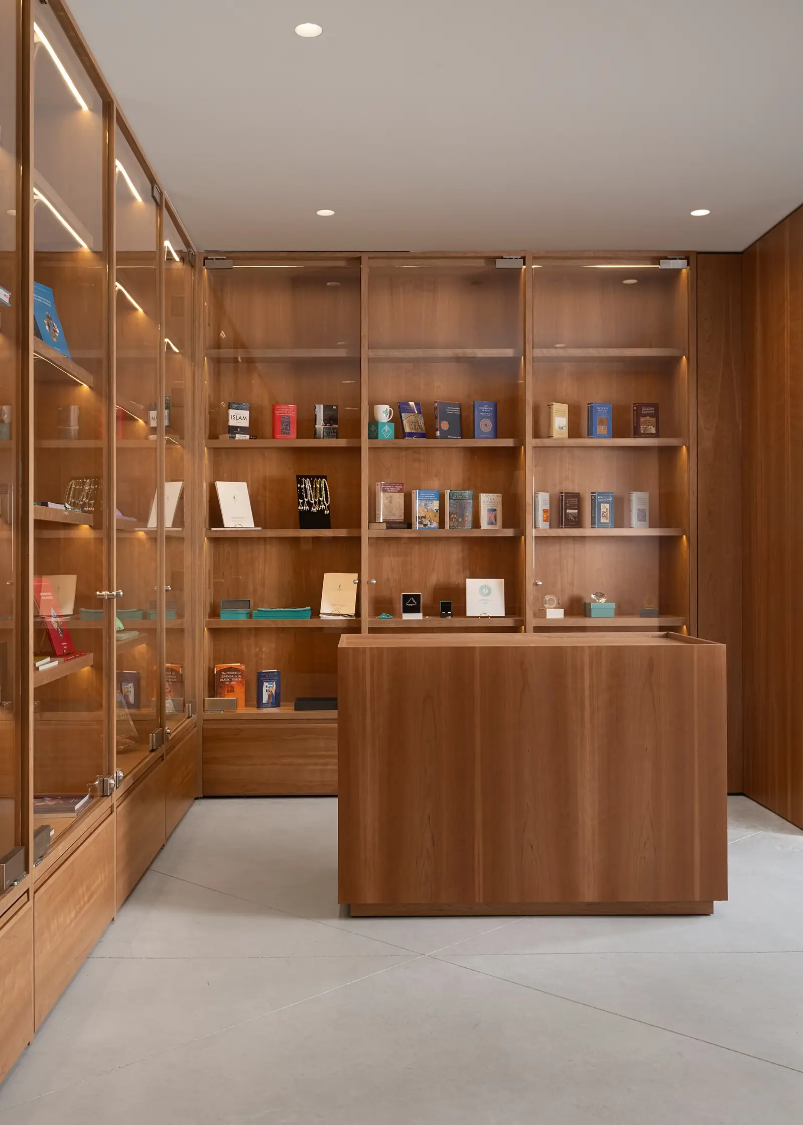 Ismaili Centre glass-fronted wood display cabinets with a wood counter