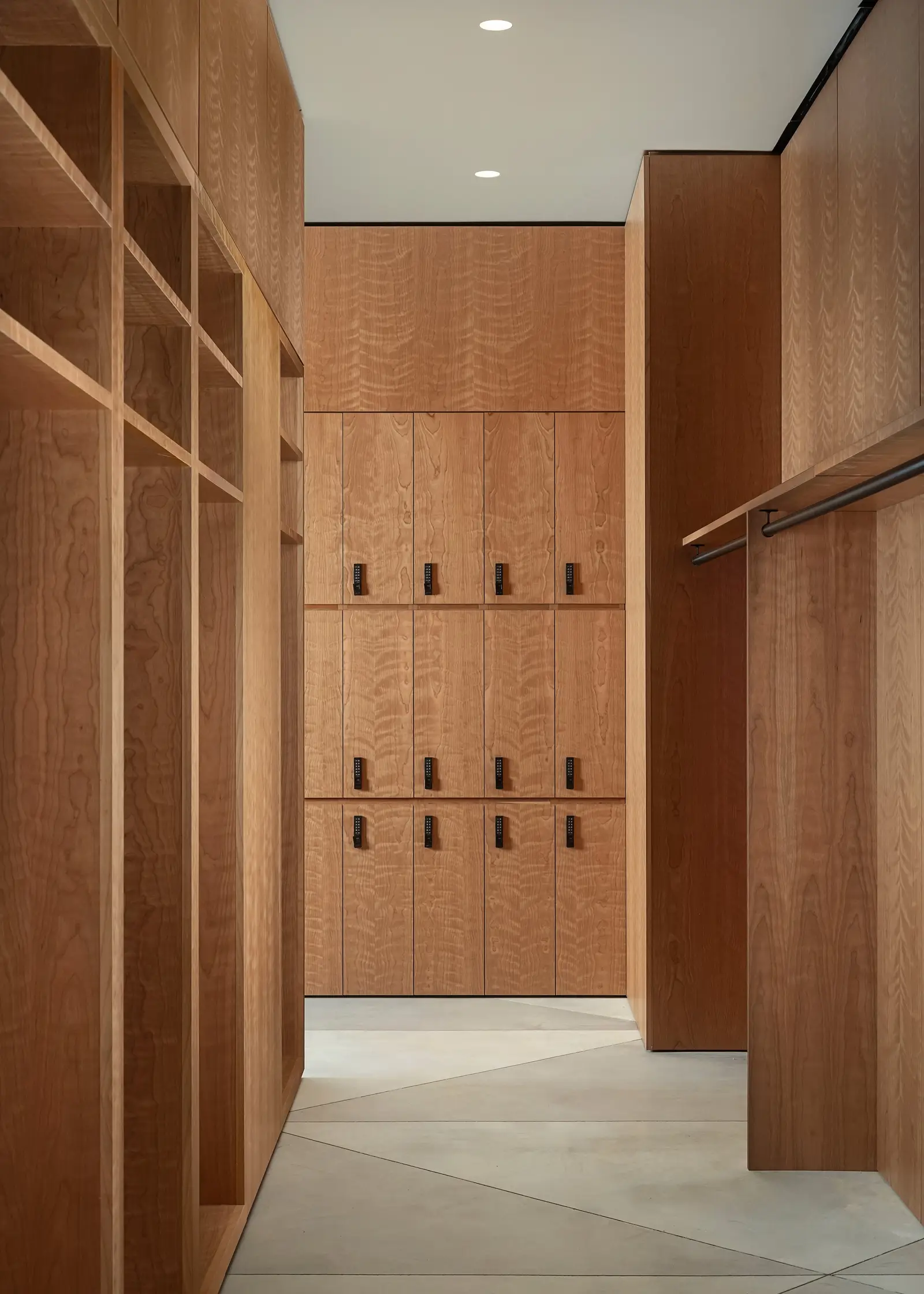 Ismaili Centre wood locker room with open cubbies and coat hooks