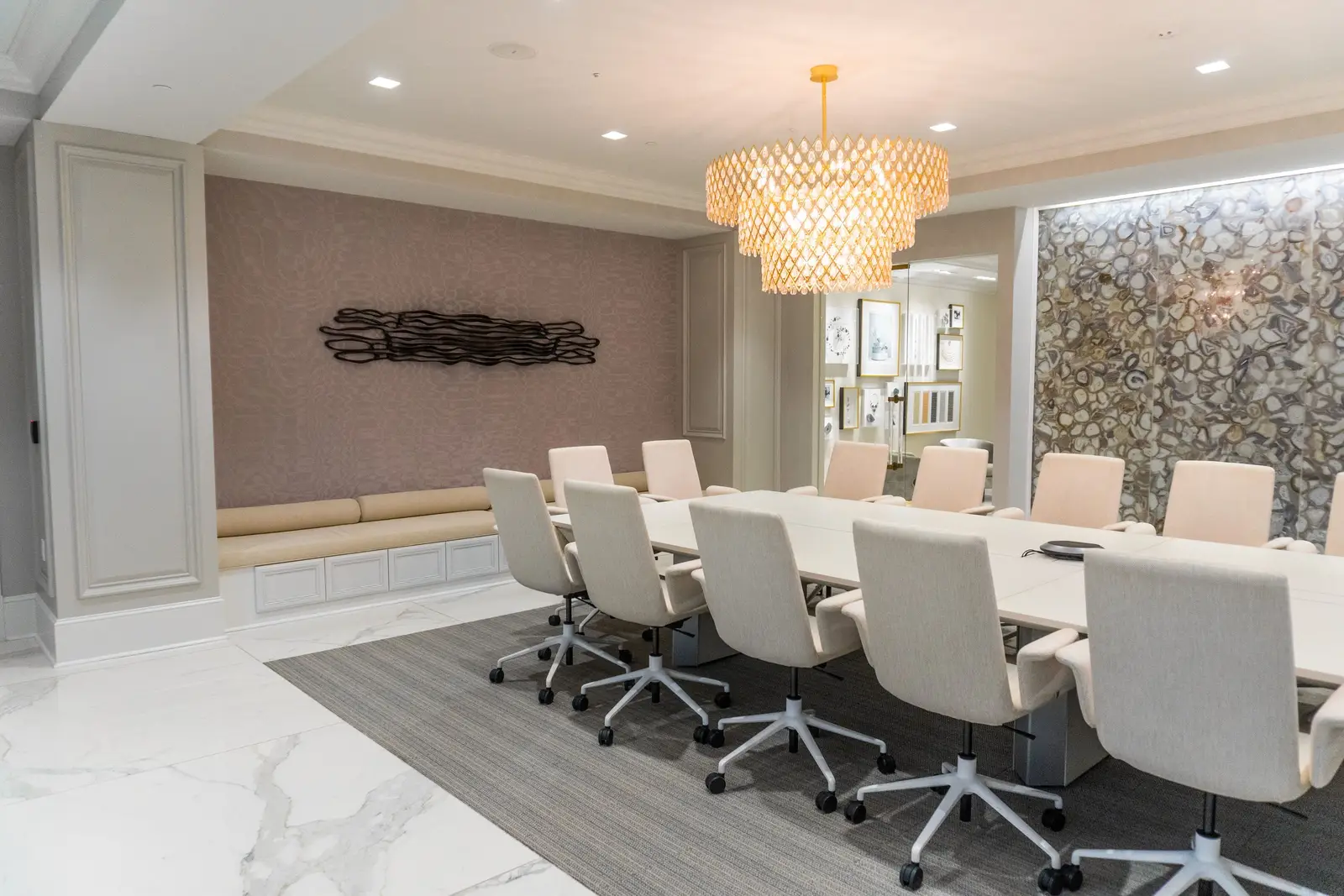 Kendra Scott conference room with a long table and a crystal chandelier