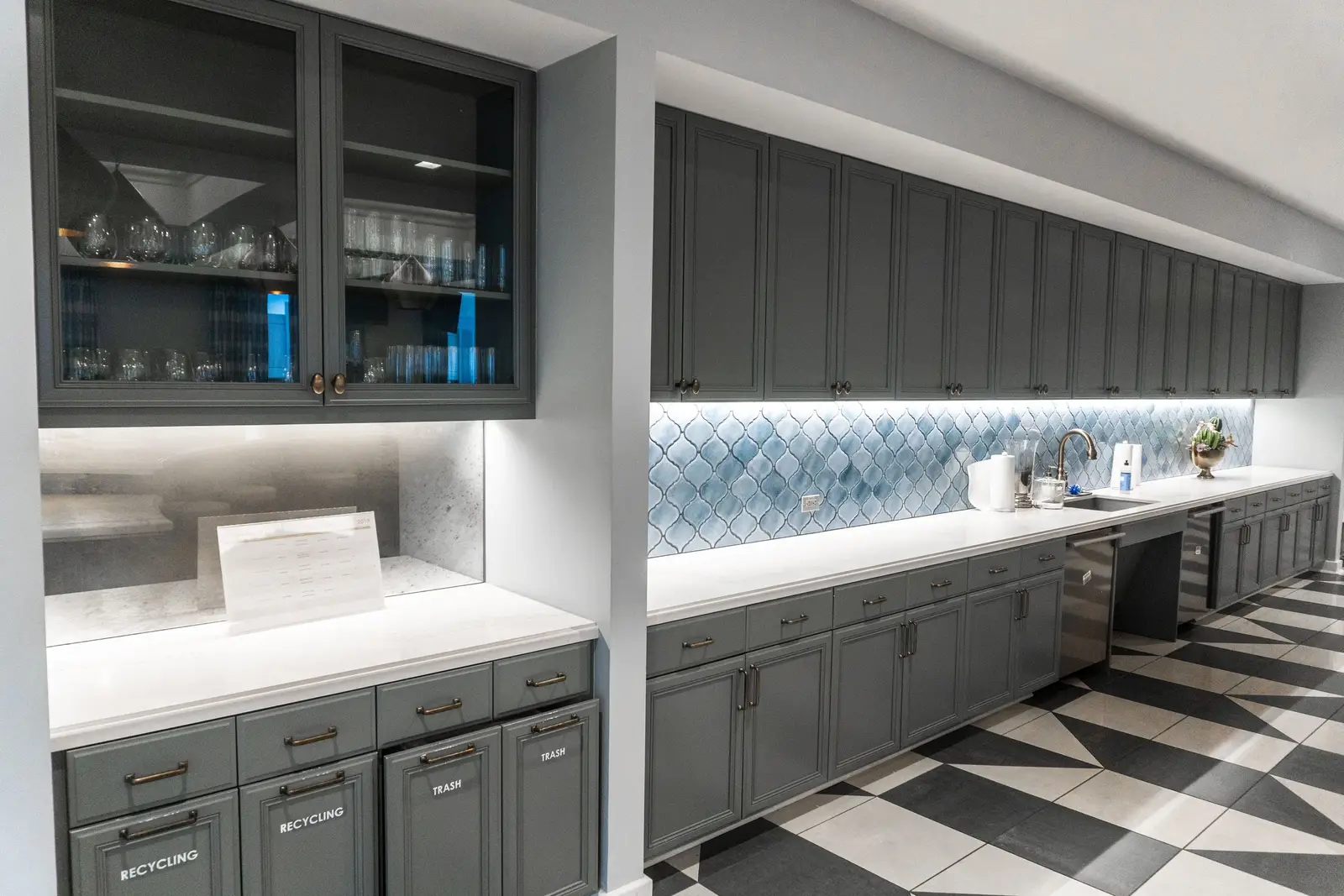 Kendra Scott pantry cabinets with a blue tile backsplash