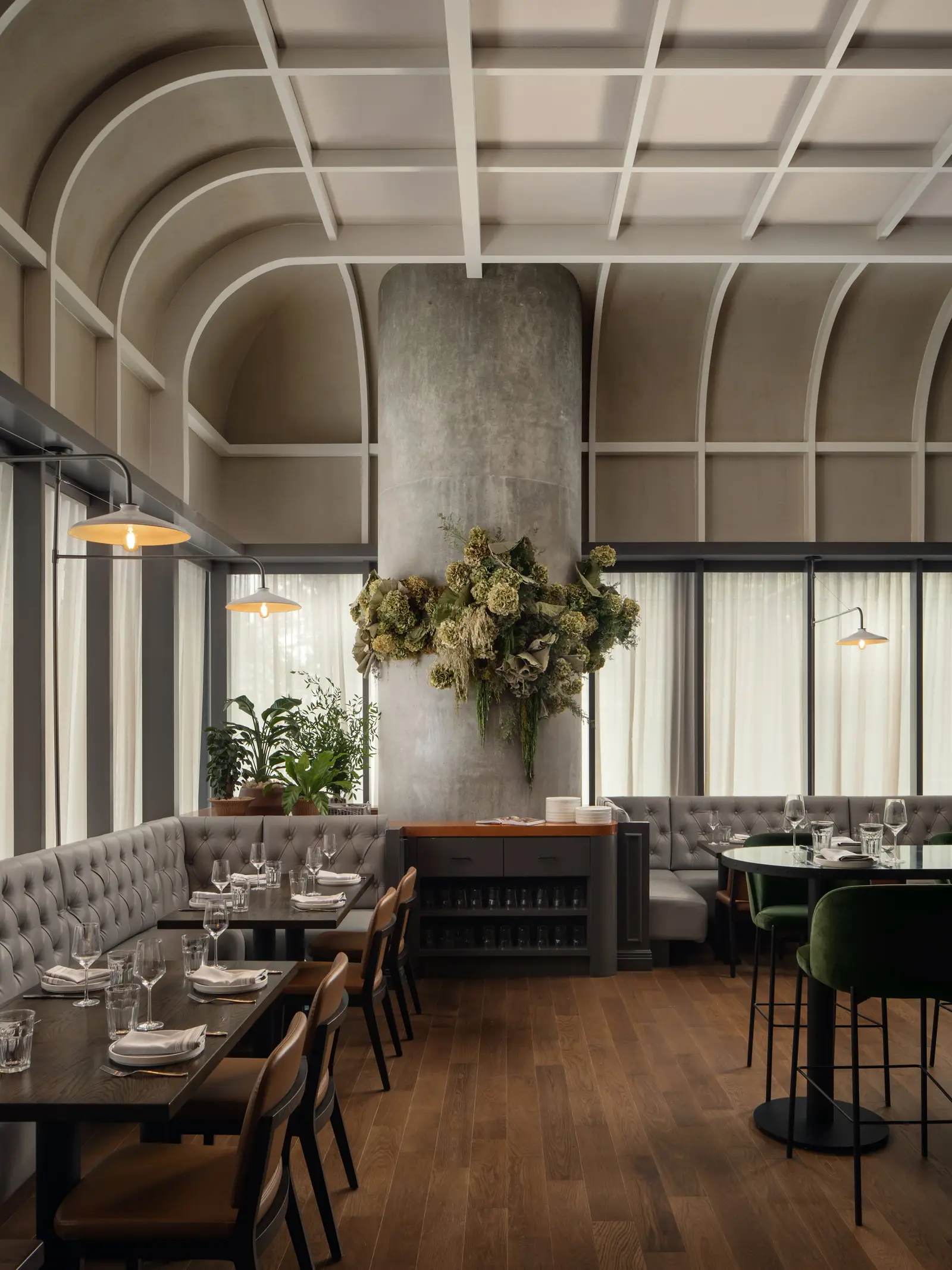 The Kitchen Bistro dining room with a banquette, vaulted ceiling and concrete column