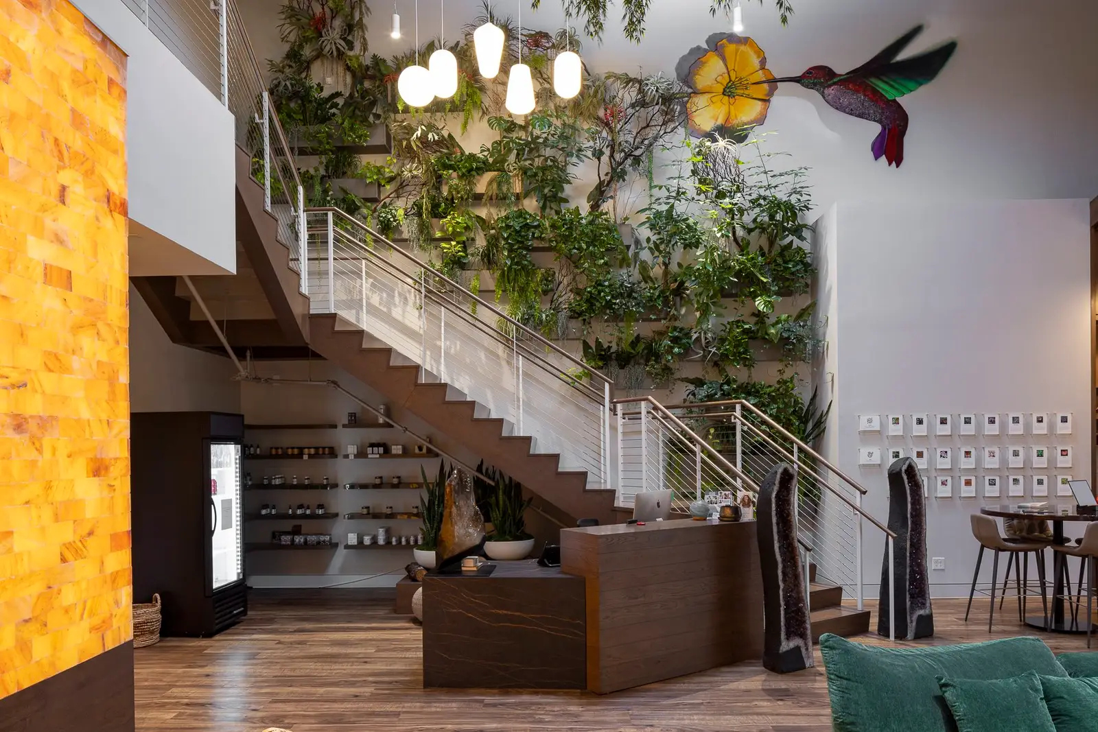 Kuya Wellness lobby with a stair, a green plant wall and a reception desk