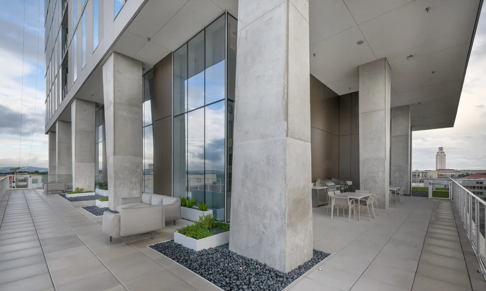 Linden Residences outdoor terrace with concrete columns, seating and city views