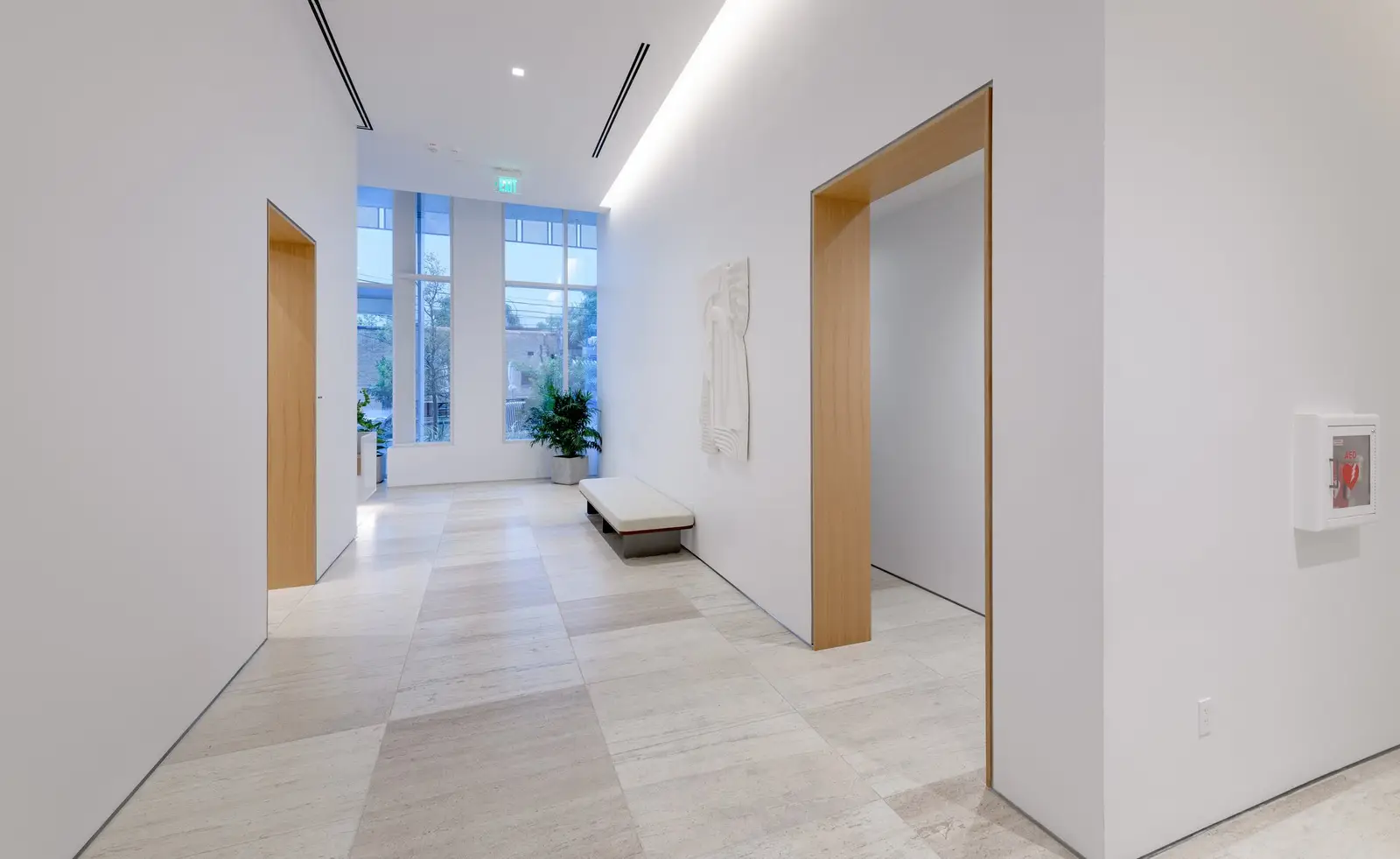 Linden Residences corridor with wood-framed doorways and white walls