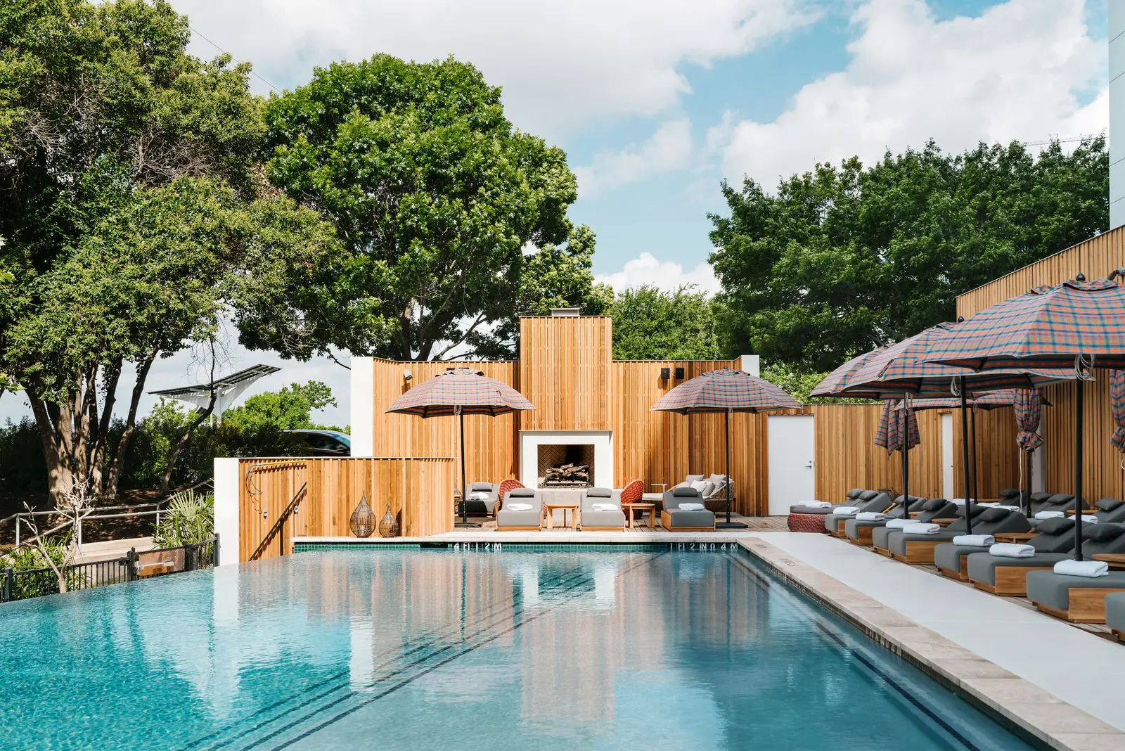 Line Hotel pool with wood fencing and lounge chairs