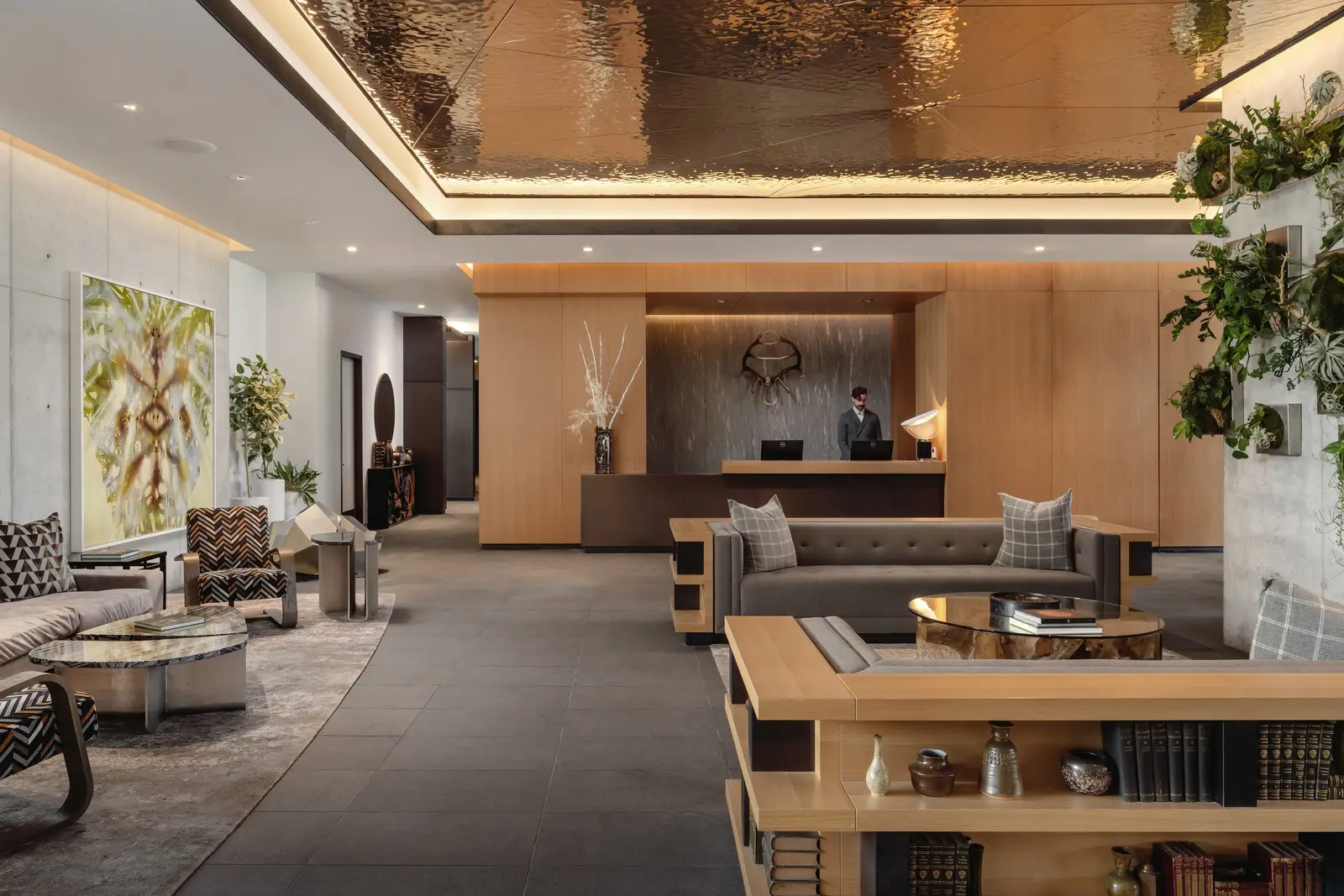 Loren Hotel hotel lobby with a wood reception desk, lounge seating and a metallic ceiling feature