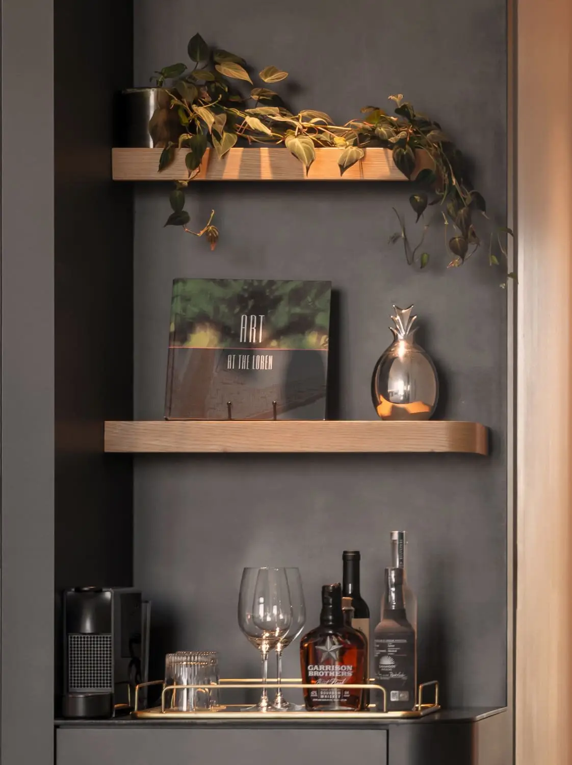 Loren Hotel wall niche with wood shelves, plants and a beverage station