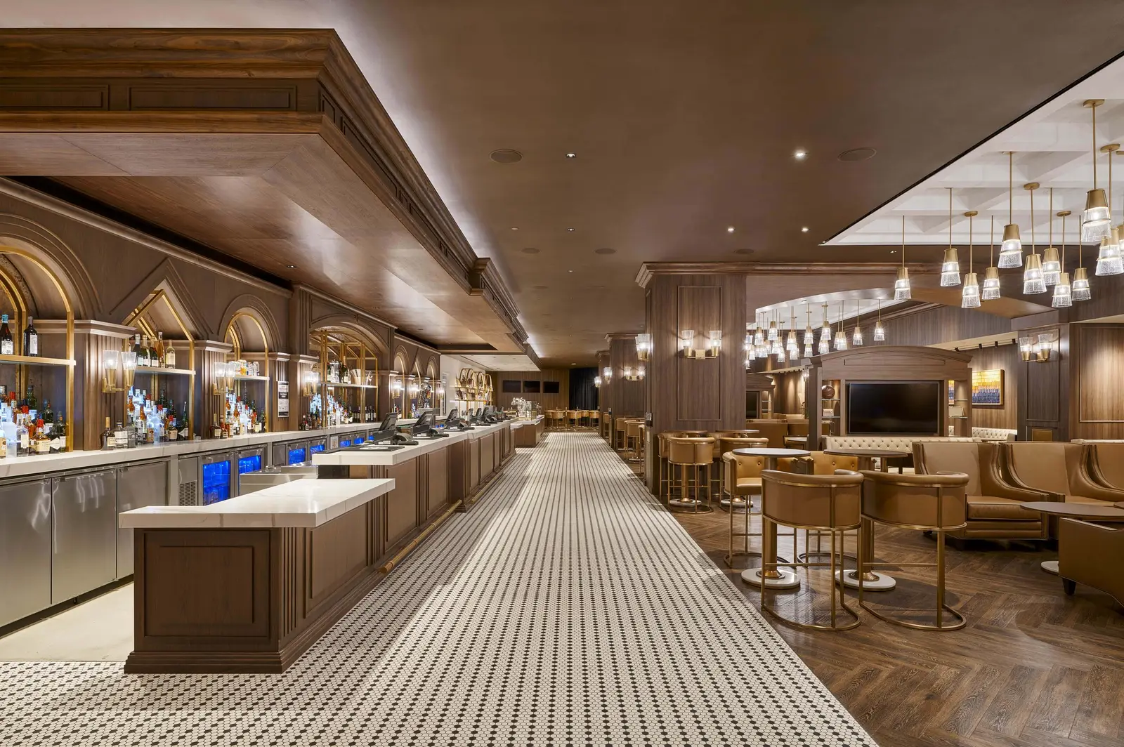 Moody Center club buffet counters beside a lounge and a tile aisle