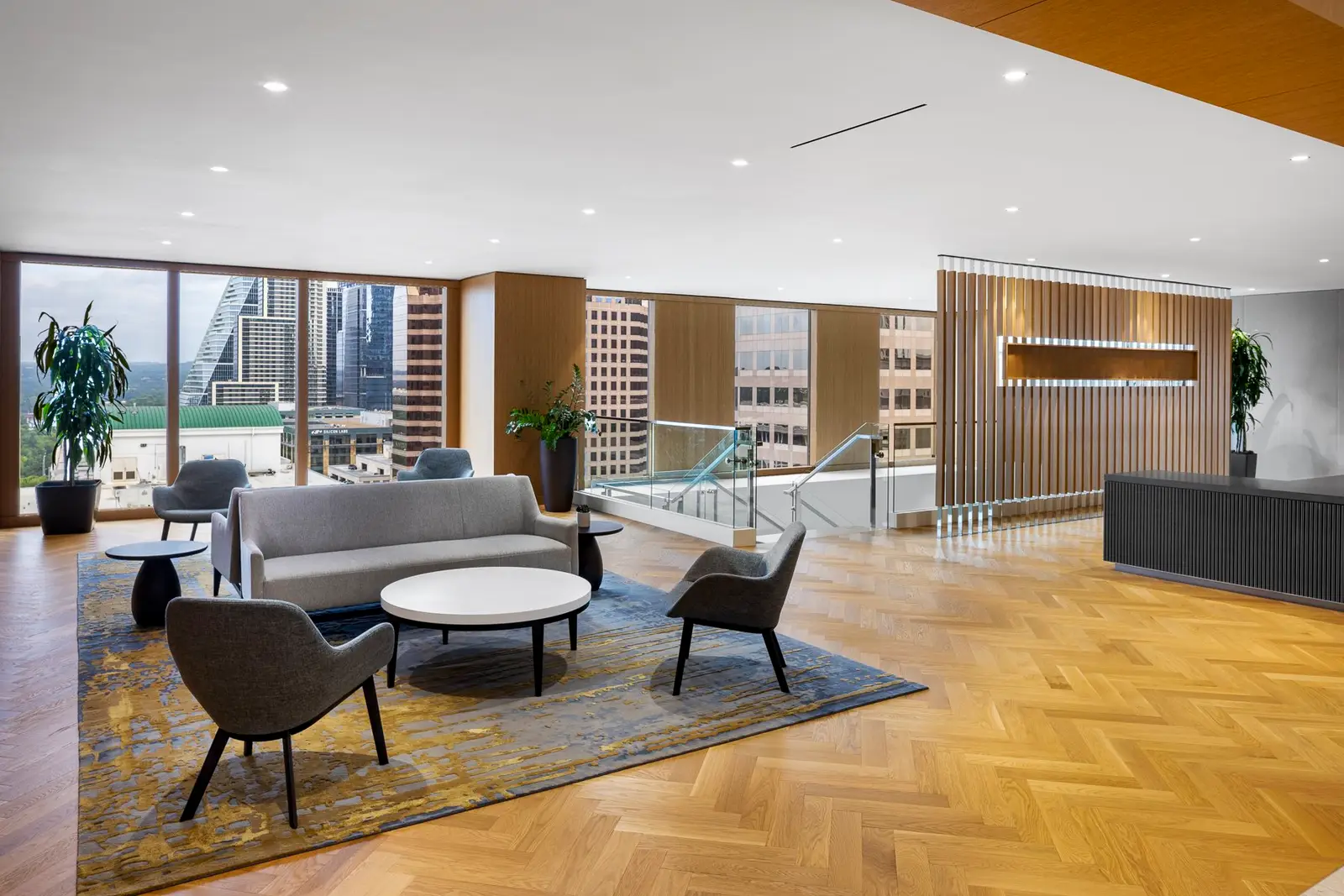 Norton Rose Fulbright reception lounge with a herringbone wood floor, seating and city views