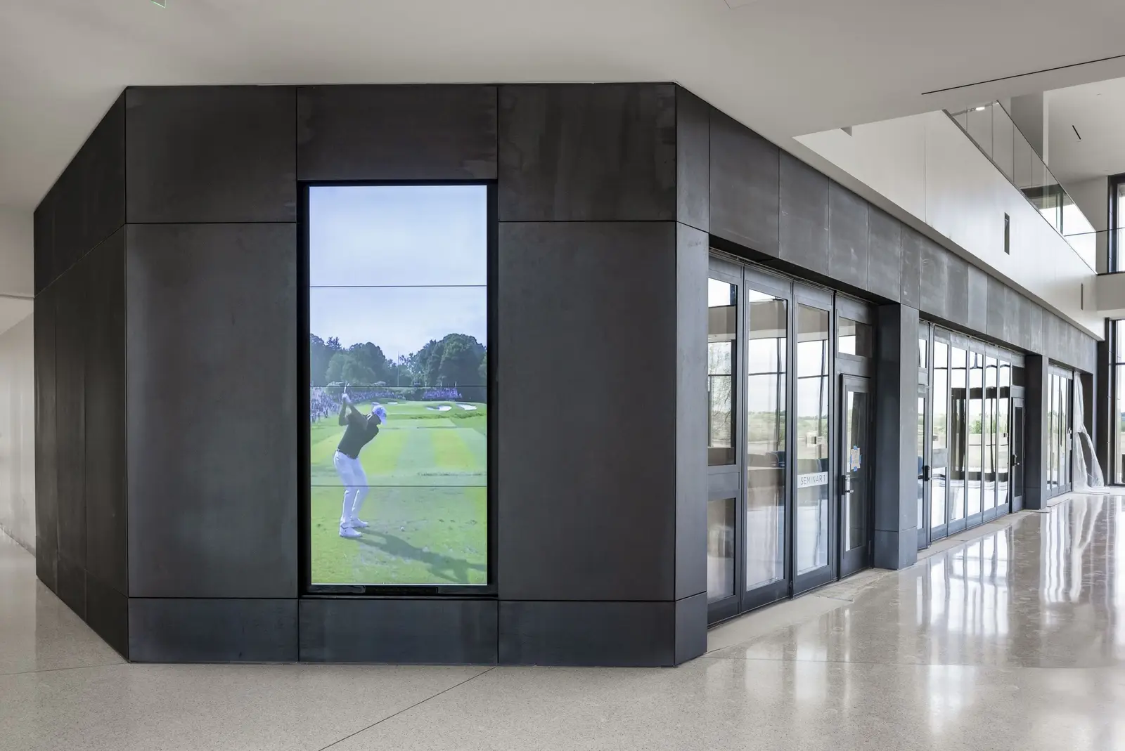 PGA of America dark metal-clad volume with a golf video screen