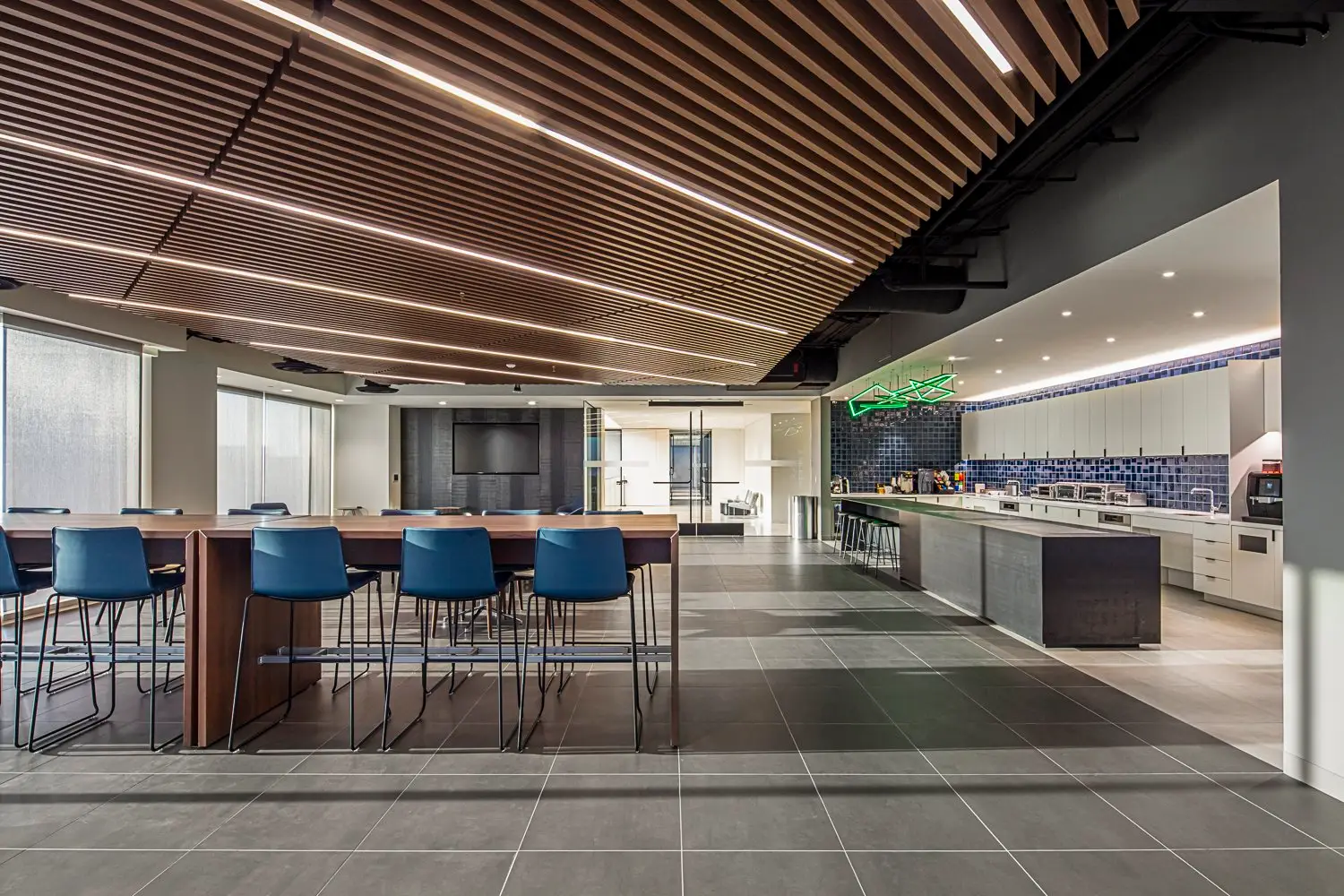 PIMCO cafe area with a wood slat ceiling, high tables and a pantry counter