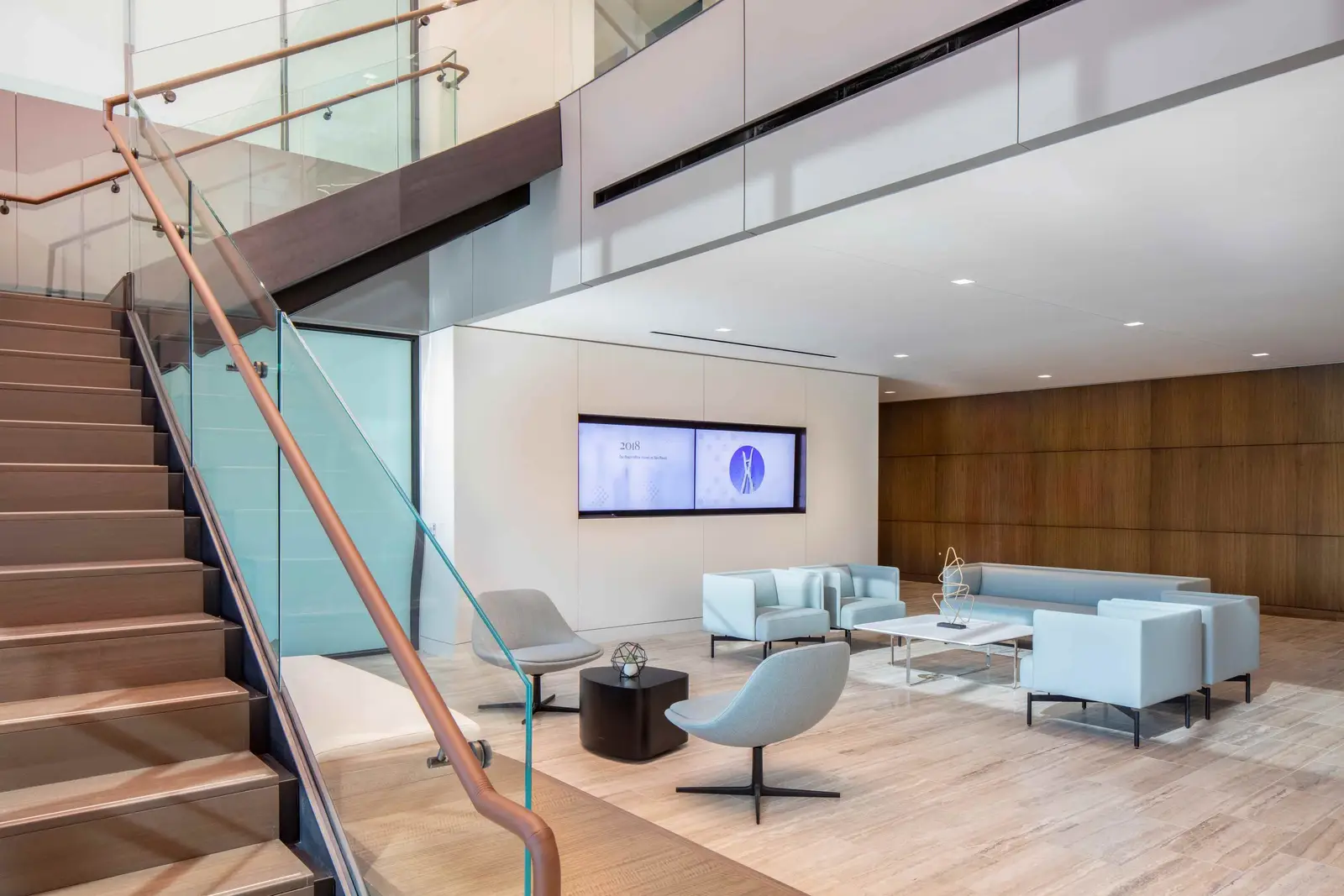PIMCO lobby lounge with a wood-tread stair and glass guardrail, repeat view