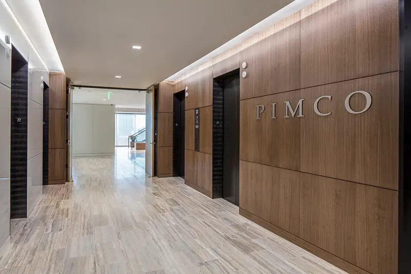PIMCO elevator lobby with a wood-paneled wall bearing the PIMCO name