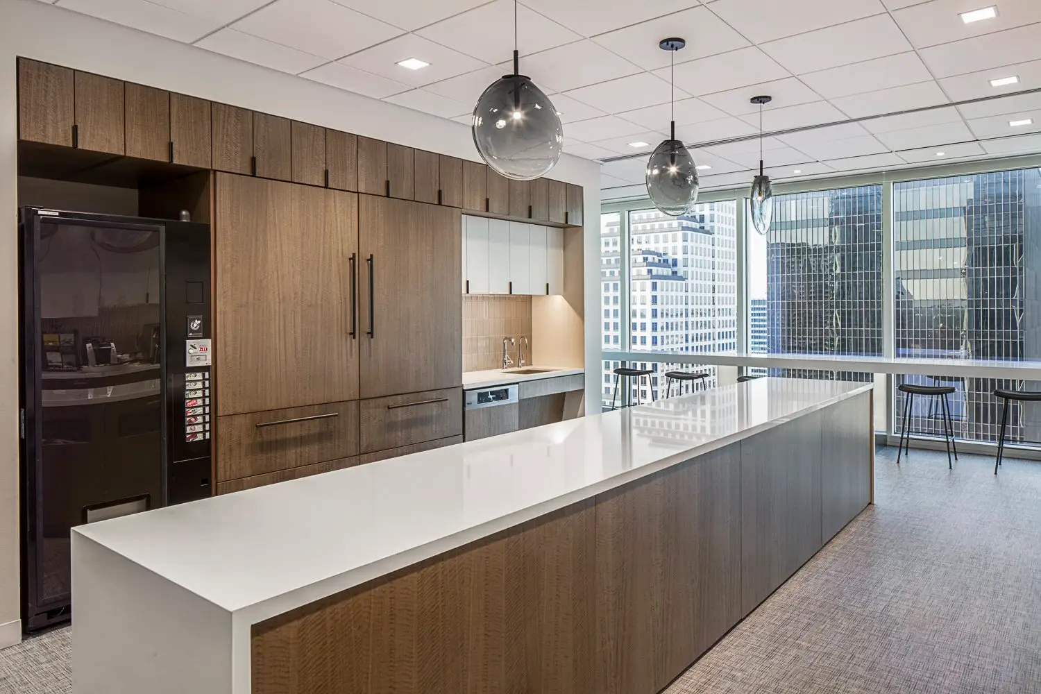 PIMCO kitchen with wood cabinets and a long white-top island