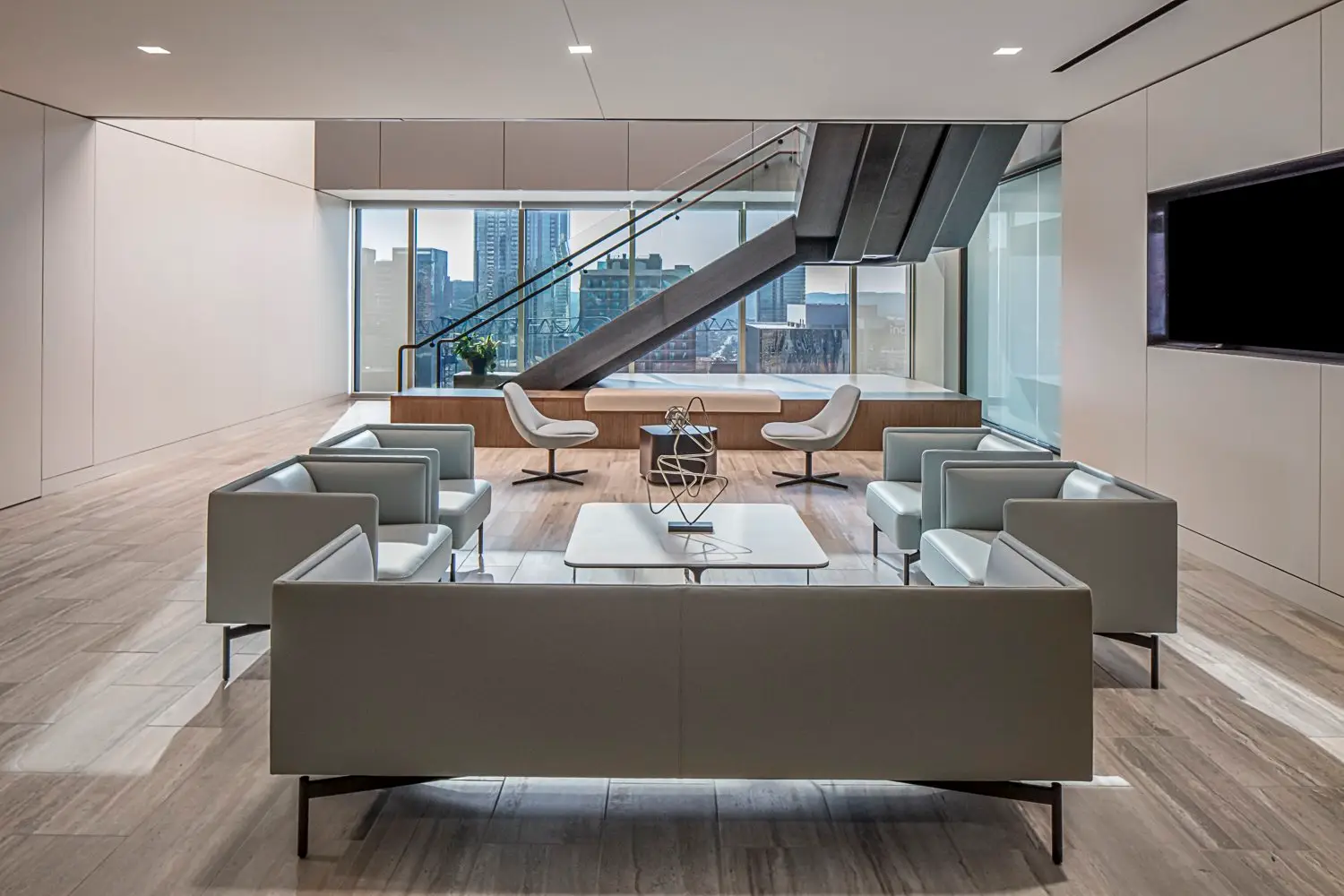 PIMCO lounge with gray sofas and a stair in the background