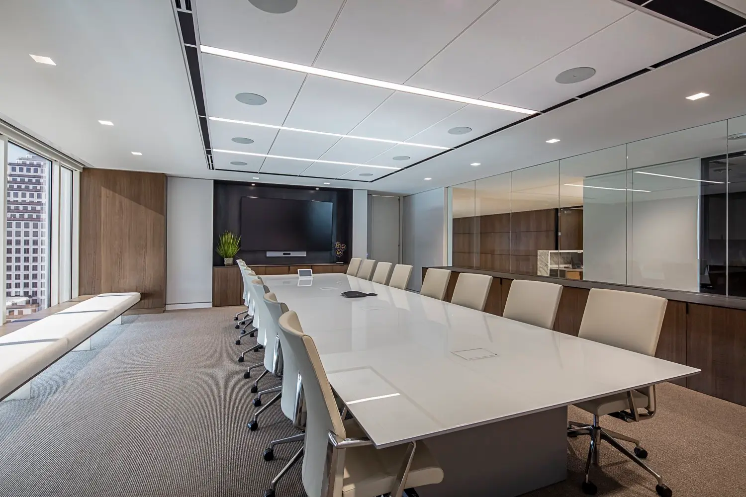 PIMCO conference room with a long white table and a window seat bench