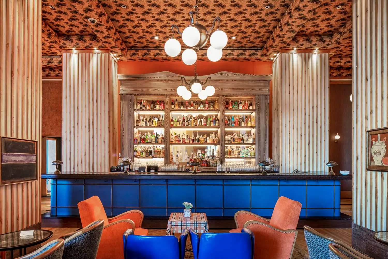 Austin Proper Hotel bar with a blue front, wood columns and a patterned ceiling