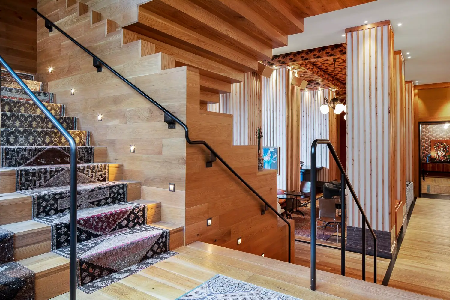 Austin Proper Hotel wood stair with patterned tile risers and a black railing