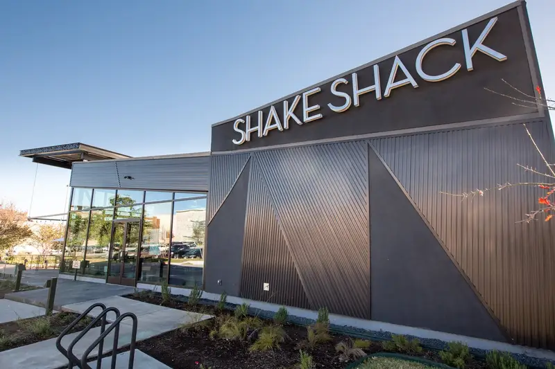 Shake Shack Domain restaurant exterior with the SHAKE SHACK sign on angled dark metal cladding