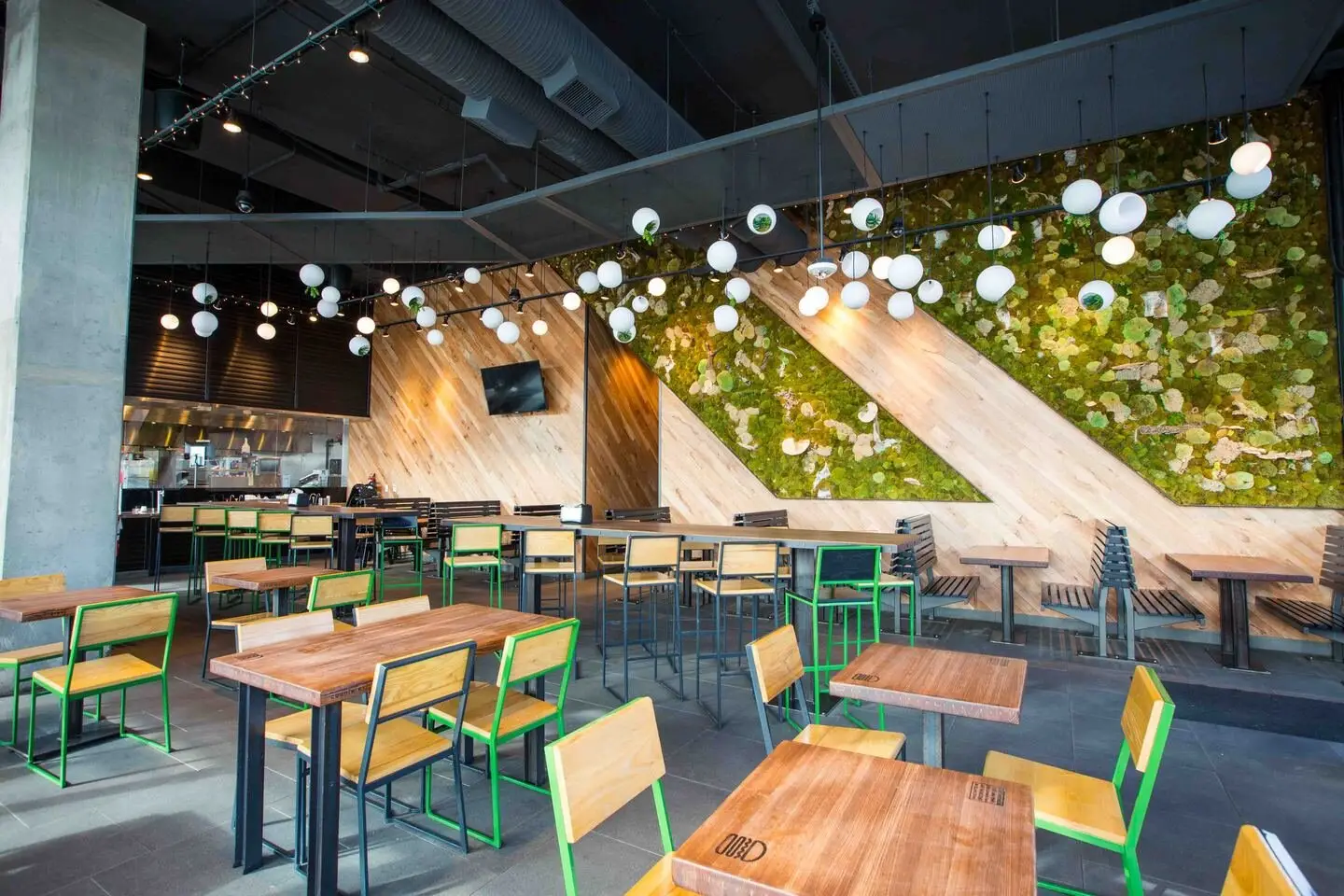 Shake Shack S. Lamar dining room with a moss wall panel, an angled wood wall and tables