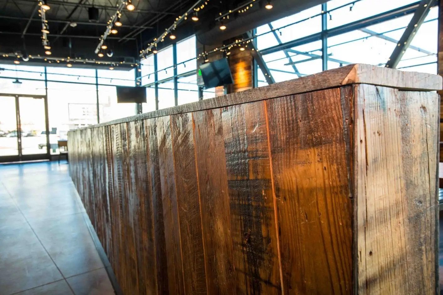 Shake Shack S. Lamar reclaimed wood counter front in a glass-walled dining room