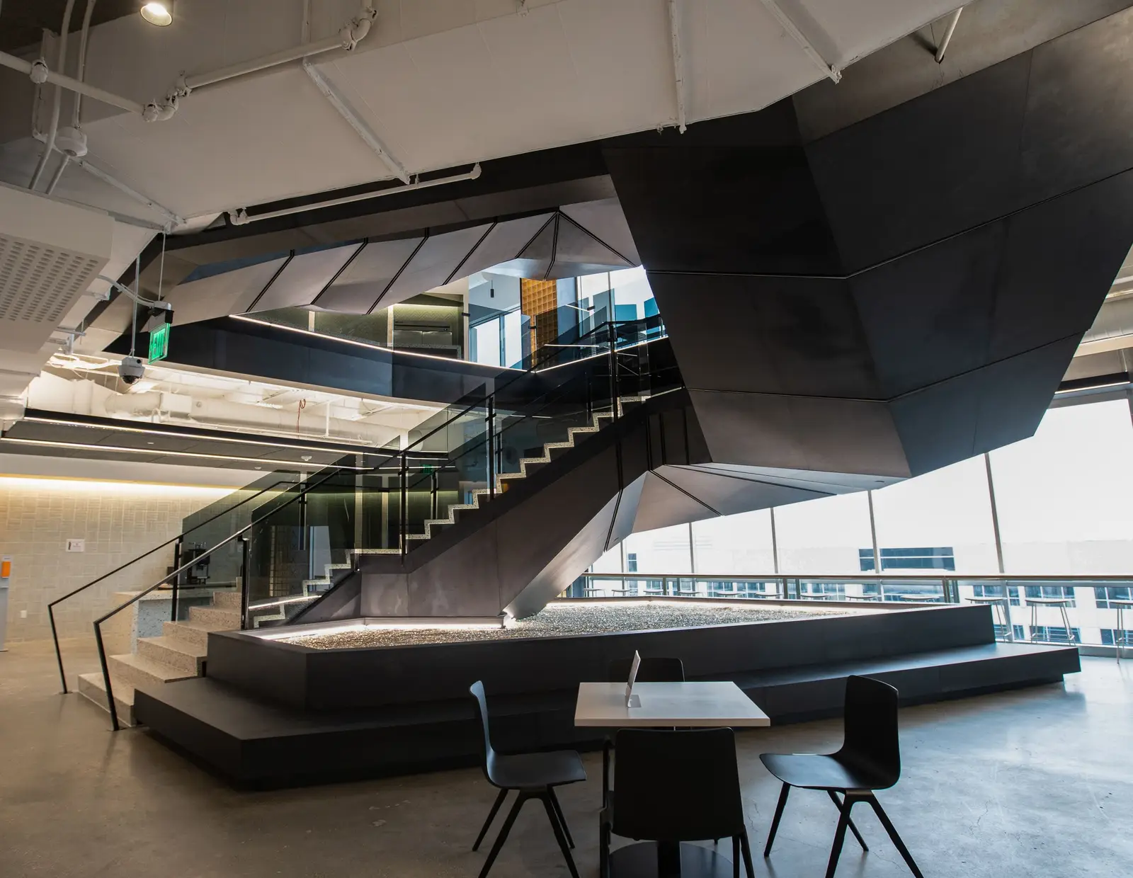 Splunk faceted black metal ceiling and stair above a platform with a table
