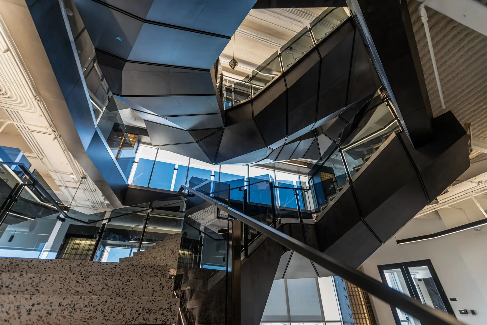 Splunk faceted dark metal stair structure seen from below