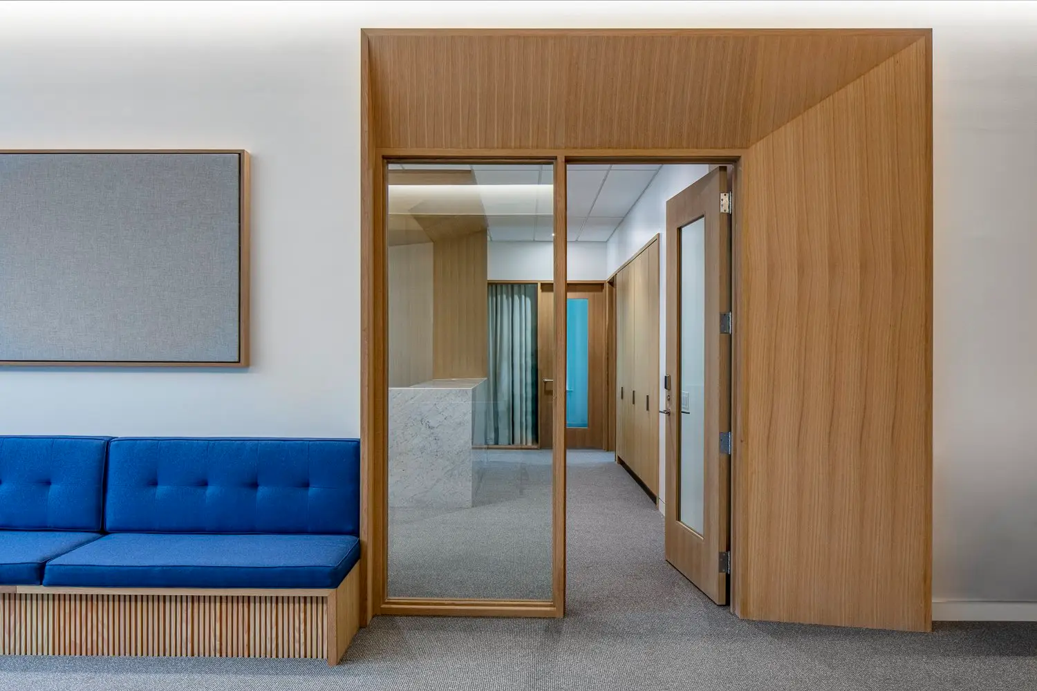 St. Edward's University wood-framed doorway beside a blue bench