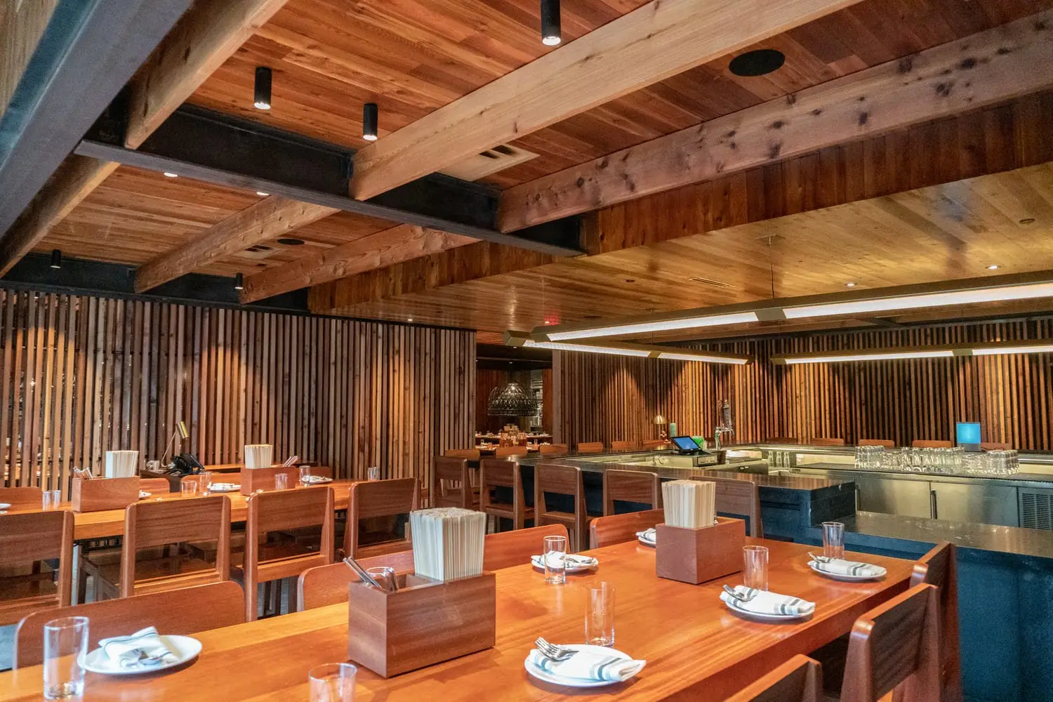 Sway Domain dining tables under exposed wood beams