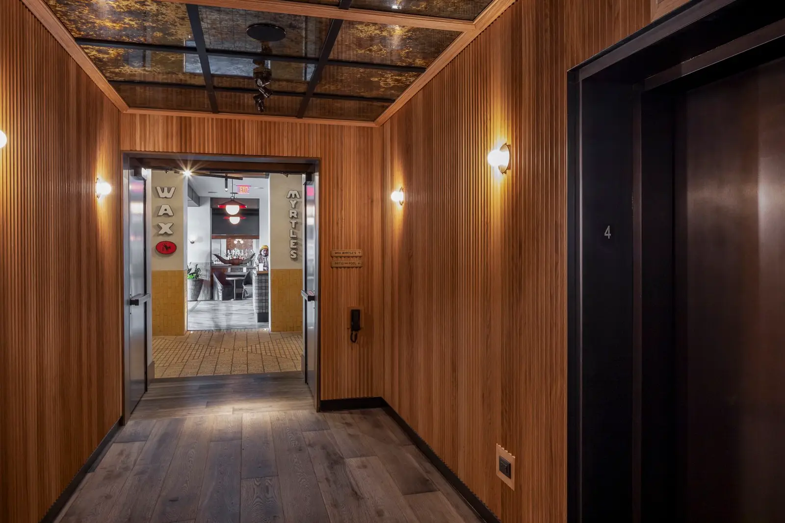 Thompson Hotel wood-paneled elevator vestibule with a mirrored ceiling