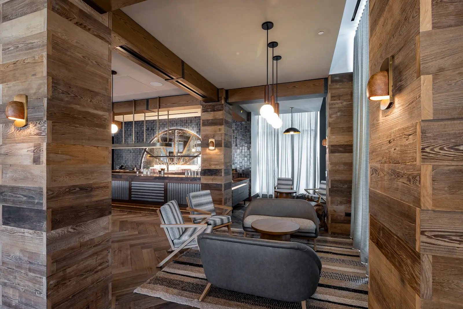 Thompson Hotel lounge with reclaimed wood walls and seating