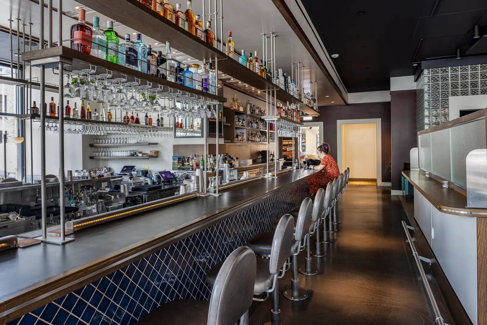 Thompson Hotel long bar with a blue tile front and stools