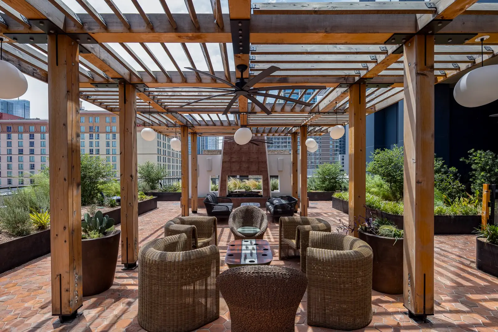Thompson Hotel rooftop pergola lounge with wicker chairs