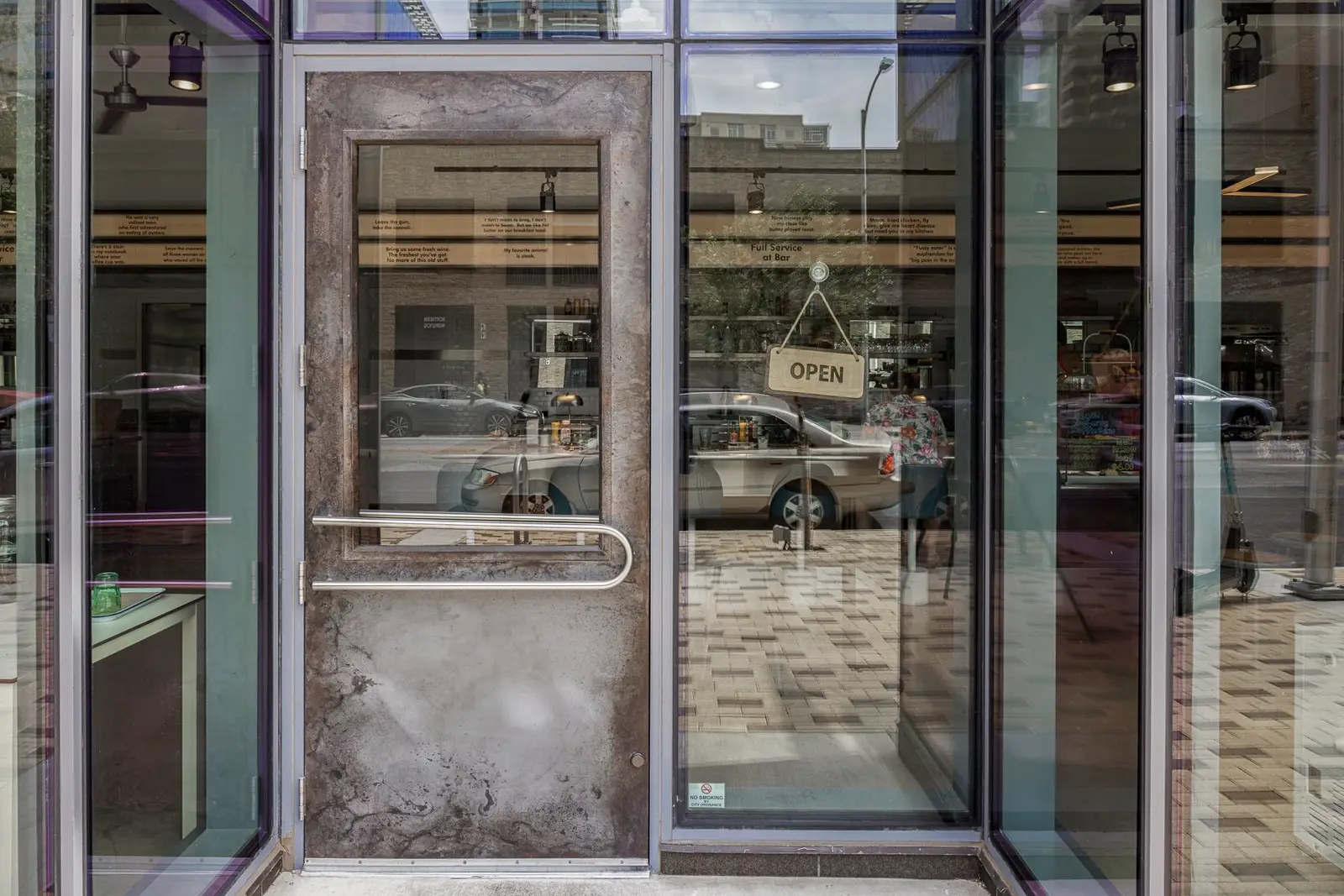 Thompson Hotel glass entry door with a heavy metal frame